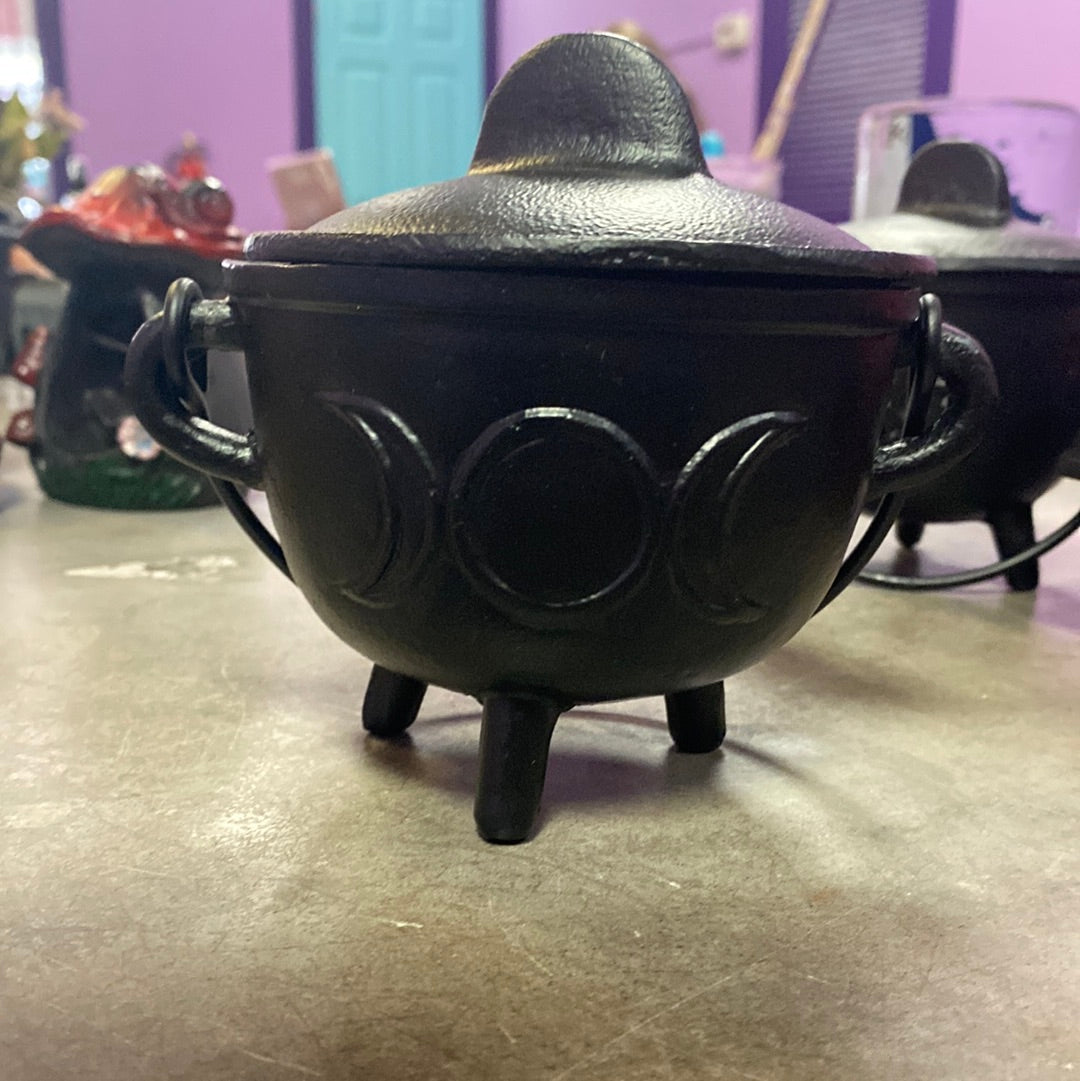 Cauldron with triple moon symbol.